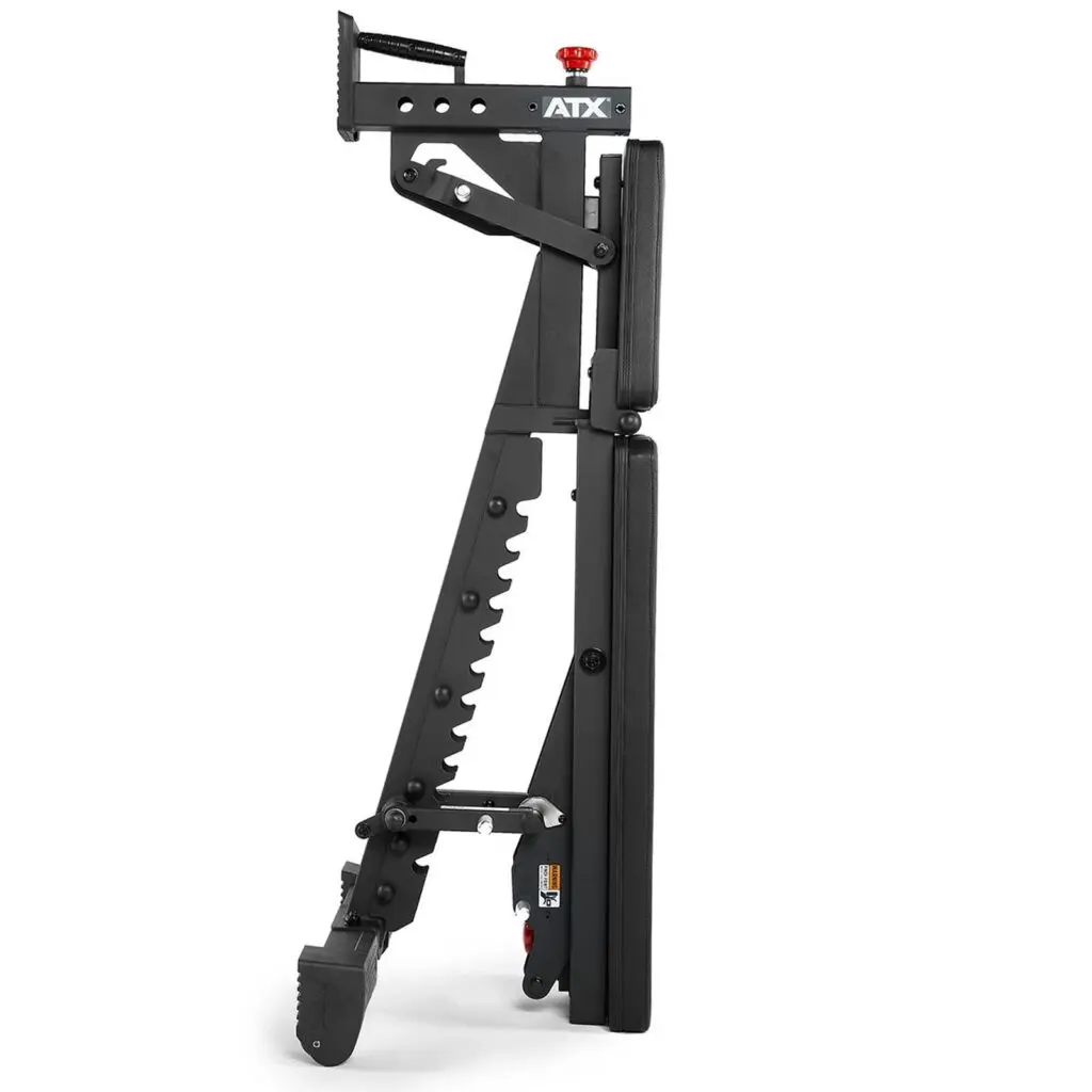 Side view of the folded ATX® Commercial FID Bench ATX-MBX-660, highlighting its compact design as a flat incline bench in black with multiple adjustment levers and wheels for easy mobility.