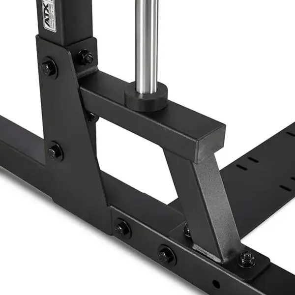 Close-up view of a black, angular metal structure with bolts from the ATX® Smith Machine 500 - Low Ceilings - 198 cm, featuring a vertical shiny metal bar positioned at the corner.