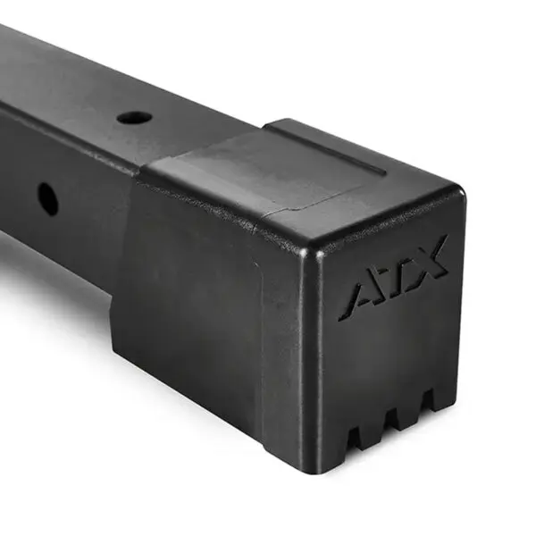 Close-up of a black metal bar with ATX on the protective end cap, part of the ATX® Smith Machine 500 designed for low ceilings (198 cm), featuring multiple holes along its length indicating modular or adjustable use.
