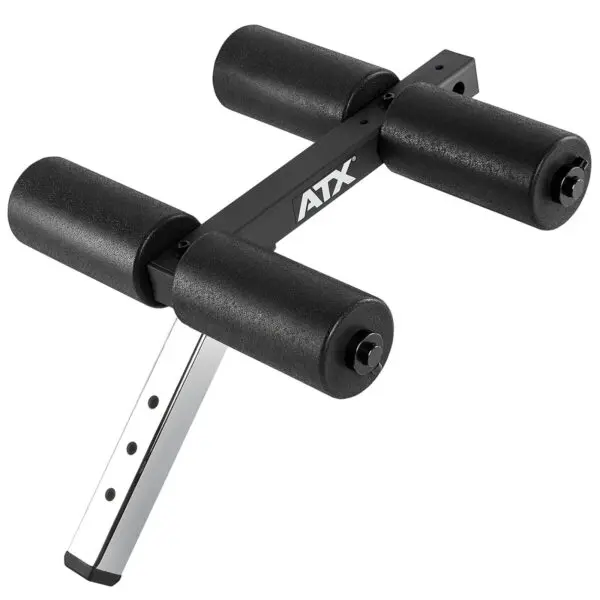 The ATX® AB Attachment is a black adjustable foam roller for a workout bench, featuring four cylindrical foam pads on a metal frame to support exercises.