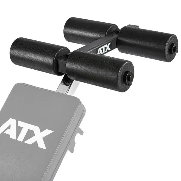 Close-up of a gym bench with black foam roller pads, featuring the ATX® AB Attachment logo. Designed for leg support or extensions, it showcases a sturdy metal frame and cushioning for comfort, highlighting the benchs detail.