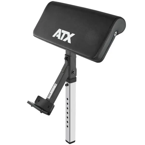 The ATX Bicep Curl Pad is an adjustable preacher curl attachment with a black padded armrest, featuring a metal frame with multiple height adjustment holes and a bracket for bench attachment.