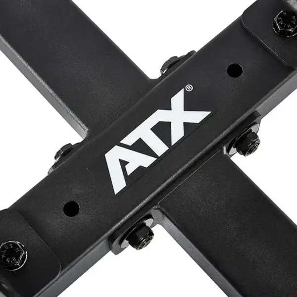 Close-up of the ATX® Attachment Storage Rack, a black metal structure with intersecting bars and a white ATX logo in the center, secured with bolts.