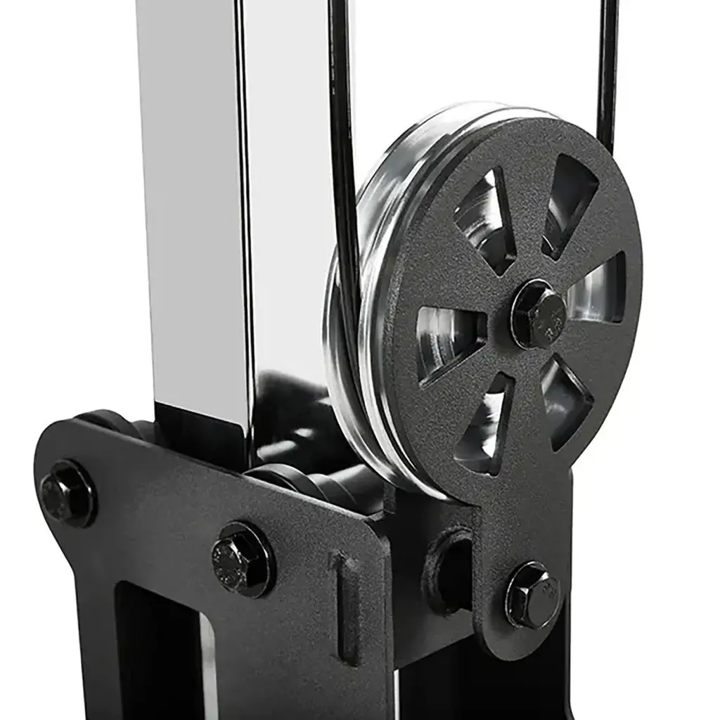 Close-up of a black and silver pulley system with a shiny metal finish, reminiscent of those on a pectoral fly machine. The pulley wheel is prominently displayed, showcasing its detailed design and attached cables.