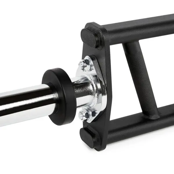 Close-up of a black trap barbell, showing the knurled handle for grip and the shiny metal bar attached. The frame is angular and designed for weightlifting exercises.