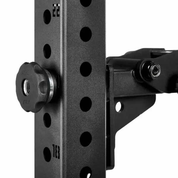 Close-up of a black metal adjustable bracket with a knob and multiple holes for height adjustment. The surface has a textured finish, and there are visible bolts securing the components.
