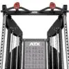 Close-up of a gym equipment structure with pull-up bars and handles. The machine has adjustable weights and an ATX logo, and features a chart illustrating different exercises.