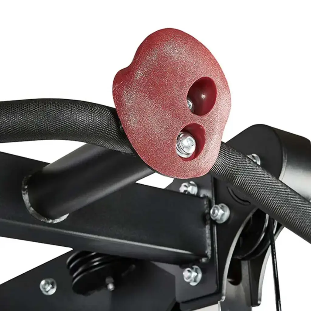 Close-up of a red rock-climbing hold attached to a black metal bar, part of a gym or climbing frame setup. The hold has two visible bolt attachments and a textured surface.