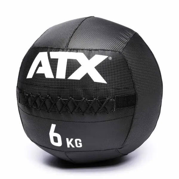 The ATX® Wall Balls PVC is a black, textured medicine ball featuring ATX and 6 KG in white, with stitched detailing across the middle.