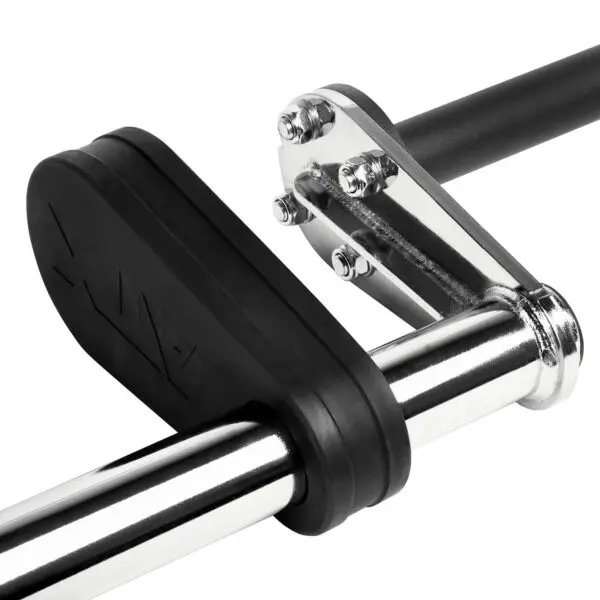 Close-up of a safety squat bar resting on a metal rack with black padding. The barbell features shiny silver with black end caps, and the rack shows bolts and a sturdy design. The brand name is visible on the padding.