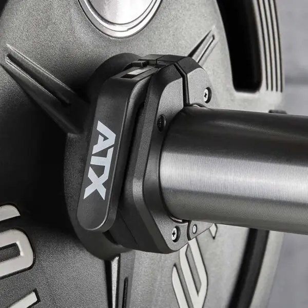 Close-up of a weightlifting barbell with an ATX® Magnetic Collar 50mm securing heavy weights. The durable collar, designed for robust construction, stands out against a neutral background, highlighting its reliability and sleek design.