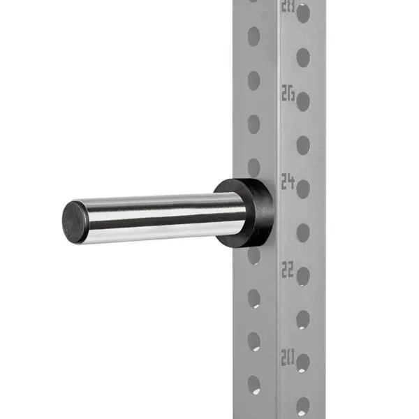 A silver barbell holder is attached to a gray, perforated metal frame with numbered holes for adjustable height settings. The frame features black retaining rings, while the holder extends horizontally.
