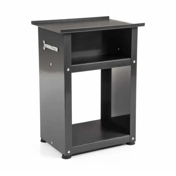 The sturdy black Ironmaster stand, with a flat top surface, open shelf, and base storage, is ideal for organizing gym equipment like Ironmaster Quick-Lock Adjustable Dumbbells. It adds style to your space with its sleek logo on the side.