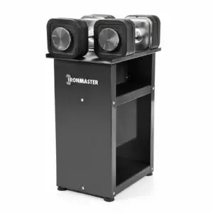 A set of Ironmaster Quick-Lock Adjustable Dumbbells rests on a sleek, modern black stand with visible weight markings. This sturdy, compact stand has two shelves for storage, perfect for organized fitness enthusiasts.