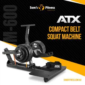 A black ATX M-600 compact belt squat machine with weight plates is displayed on a yellow and black background. Text reads Sam’s Fitness, ATX Compact Belt Squat Machine, and samsfitness.com.au.