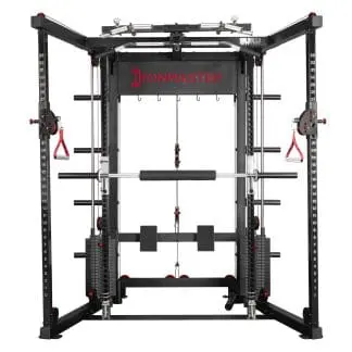 Front view of a multifunctional Ironmaster gym machine with adjustable pulleys, a pull-up bar, weight storage pegs, and a barbell for strength training exercises. The machine is black with red accents.