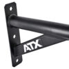 Close-up of a black metal ATX® Chin Up Bar Wall Mounted, showing a triangular support and white ATX letters. The bar is fixed to a flat vertical surface with bolt holes for mounting.