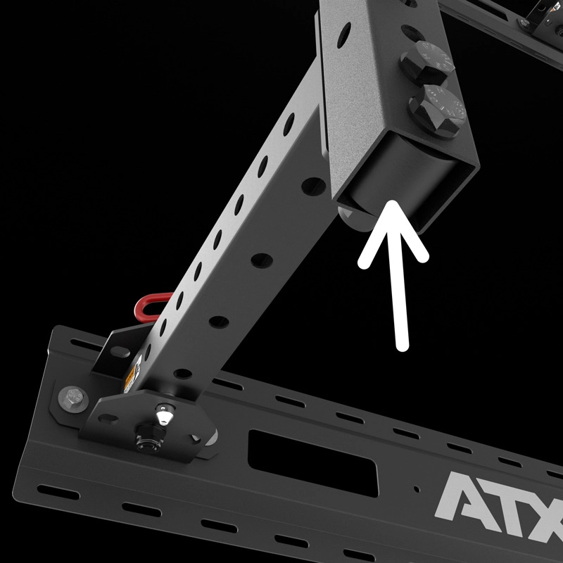 Close-up of a black metal bracket with multiple holes and bolts, featuring an arrow pointing to the end of a rectangular tube, mounted on the ATX® Fold Back Rack - Wall Mounted.