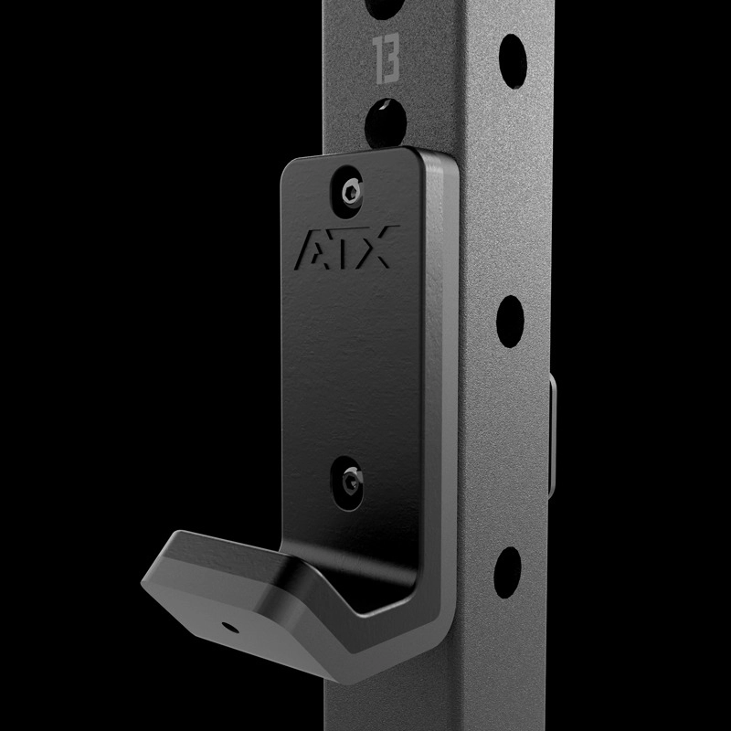 Close-up of a black metal J-cup attachment labeled ADX, mounted on the gray upright with numbered holes of the ATX® Fold Back Rack - Wall Mounted.