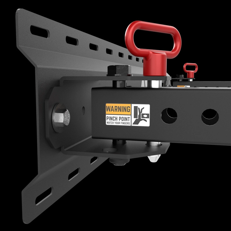 Close-up of the ATX® Fold Back Rack - Wall Mounted, showing its black metal bracket with bolts and a red handle, plus a yellow “Pinch Point, Watch Your Fingers” warning label on a black background.