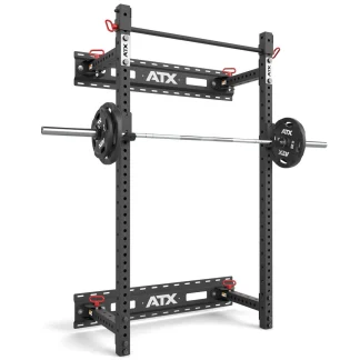 The ATX® Fold Back Rack - Wall Mounted is a black metal squat rack with adjustable safety bars, a loaded barbell, multiple customization holes, and the ATX logo on its horizontal supports.