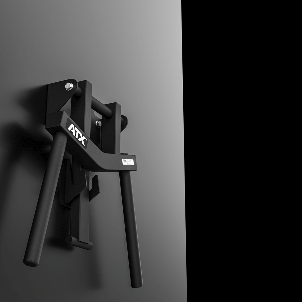 A pair of ATX® Folding Wall Mounted Dip Handles, featuring black metal construction, angled handles, and AXX branding, is showcased against a gray wall with a black background on the right side.