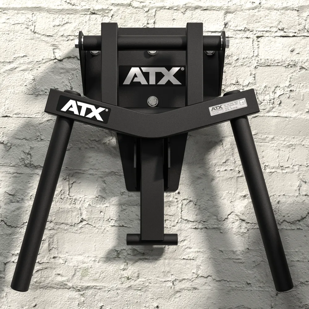 ATX® Folding Wall Mounted Dip Handles made of black metal in ATX style, featuring two angled arms, mounted on a white brick wall and viewed from the front.