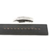 A black leather strap with evenly spaced holes is laid out horizontally, above which sits a modern silver metal clasp labeled ATX®. The clasp is detached from the strap.