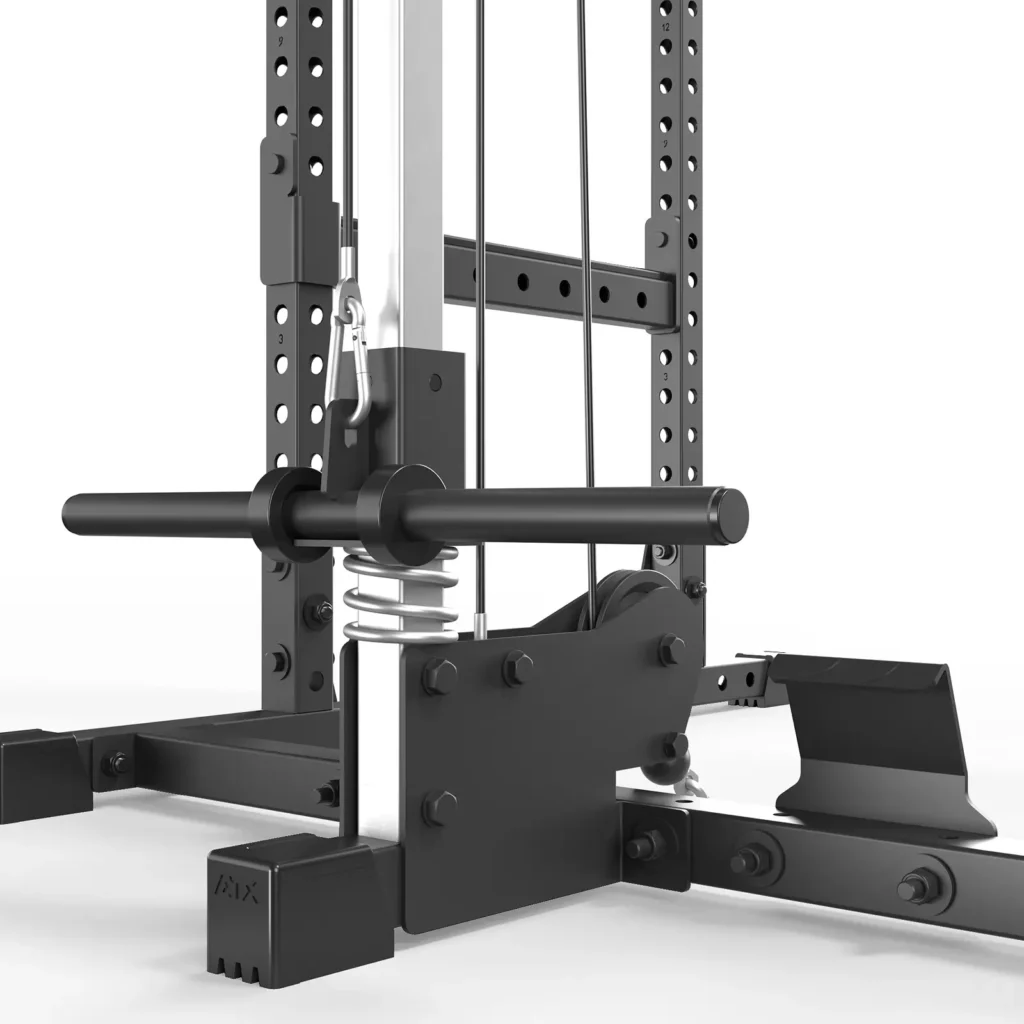 Close-up of the ATX® Power Rack 520 215cm System Plate Loaded in a gym. The image highlights its lower section with a weight stack, guide rods, and pulleys. The rack looks sturdy with a metallic frame and adjustable parts.