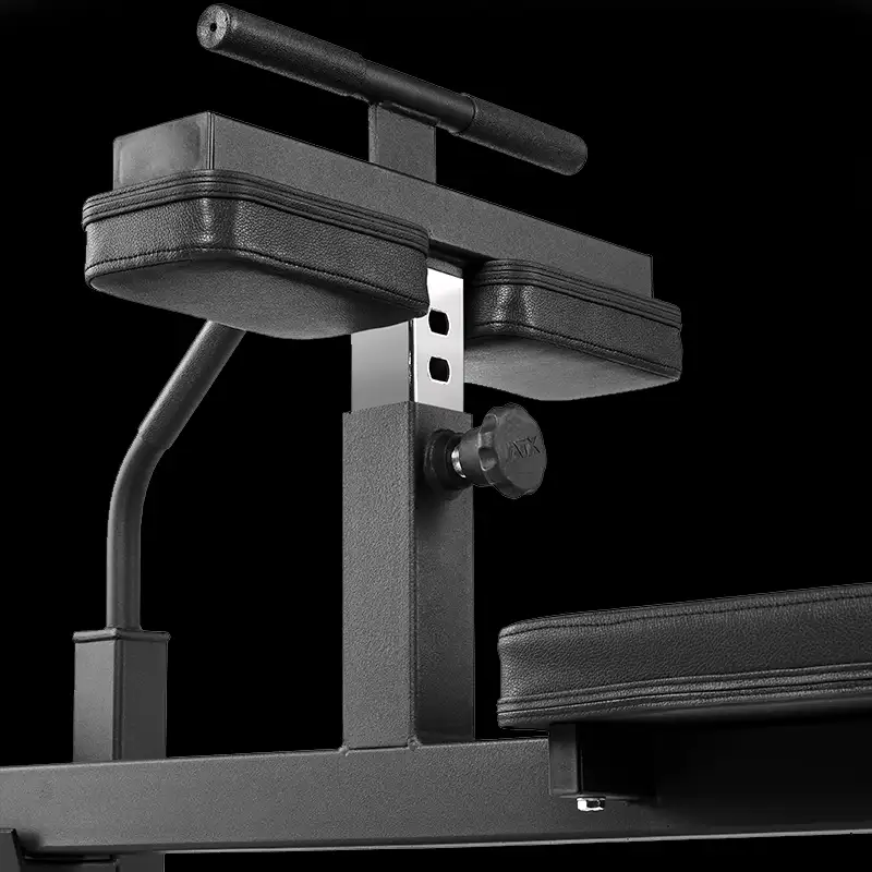 Close-up of the ATX Seated Calf Raise Machine in black, featuring padded arm supports, adjustment knobs, and a horizontal handlebar, set against a black background.