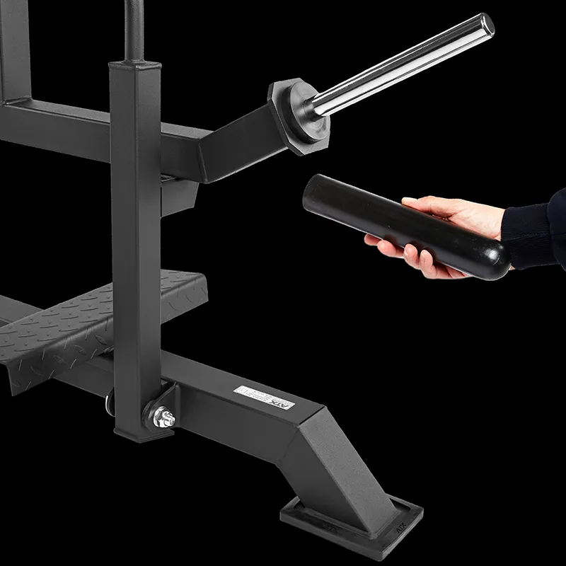 A hand holds a cylindrical object near the angled sleeve of the ATX Seated Calf Raise Machine, which has a step platform and sturdy black metal frame, all set against a black background.