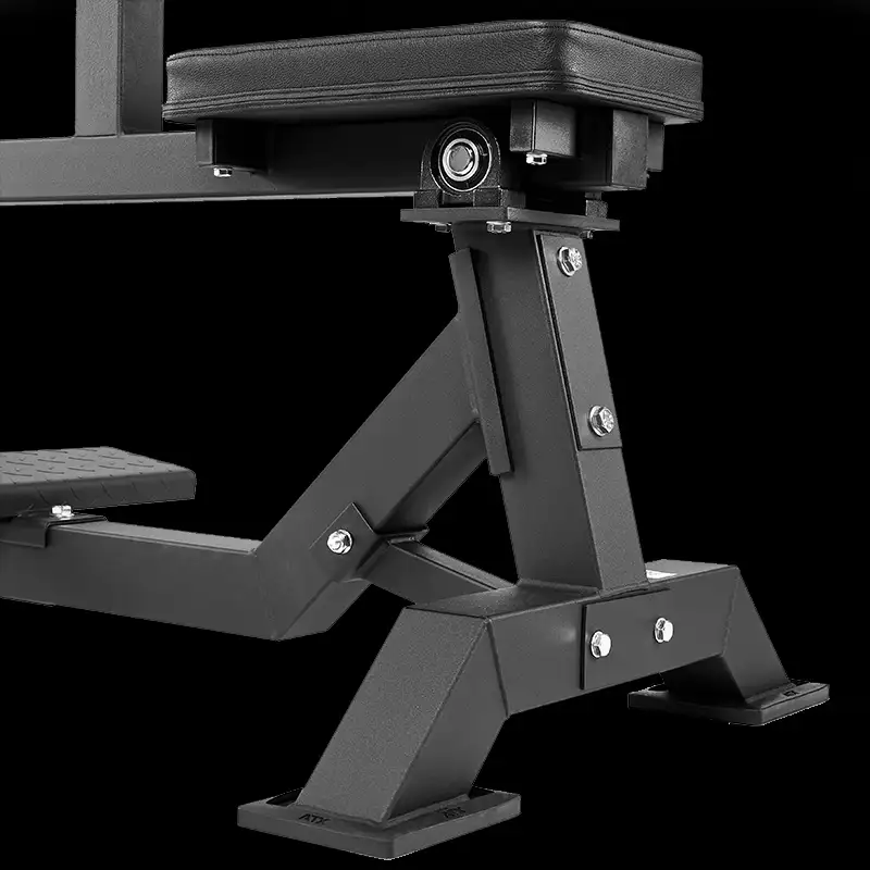 Close-up of the sturdy metal frame and padded seat of the ATX Seated Calf Raise Machine, highlighting bolts, joints, and support structures against a black background.