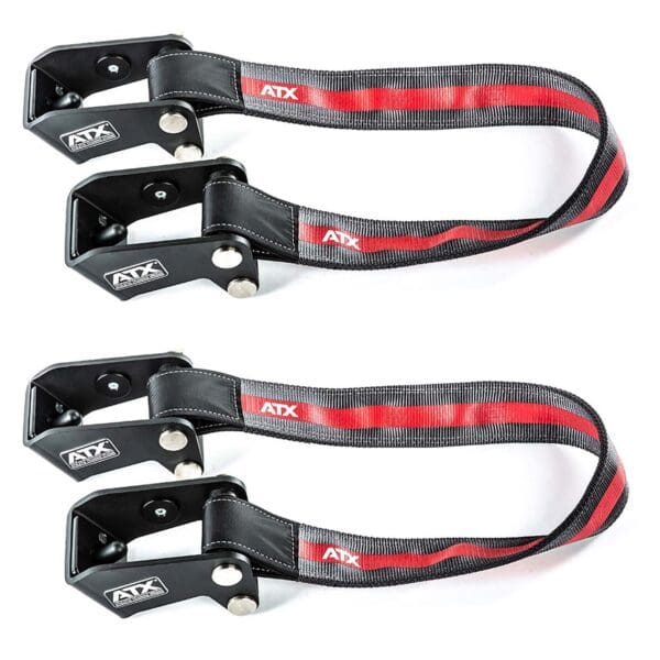 Two black ATX® Safety Strap System ski straps with red and gray stripes feature sleek metal clamps and visible bolts securing the fabric. Each strap prominently displays the brand logo, visible from a top-down view in the image.