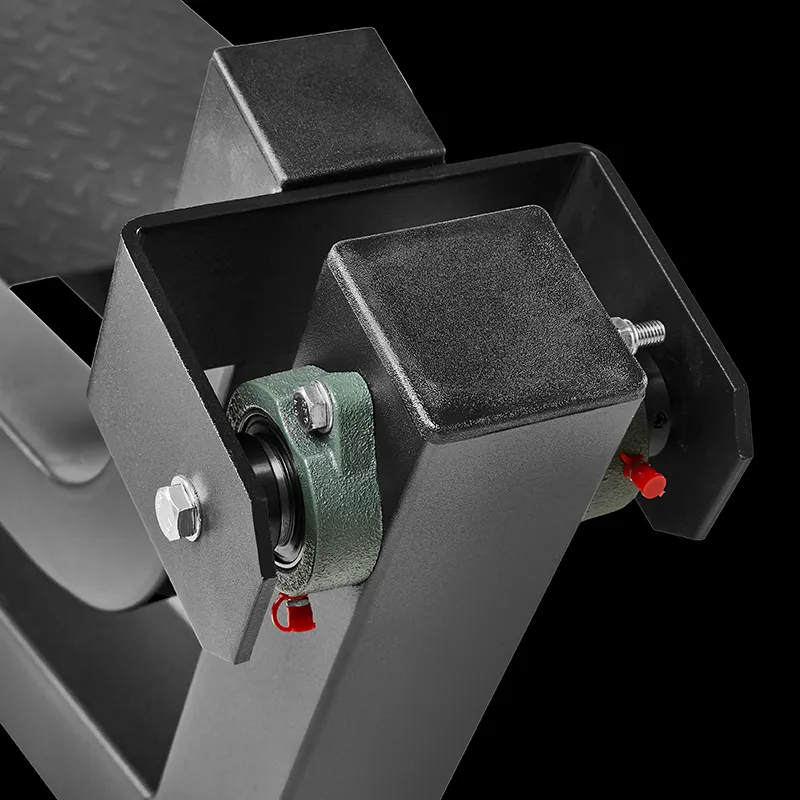 Close-up of a black metal mechanical component from the ATX® T-Bar Row Machine featuring a bolt, bearing housing, connecting parts, and red locking pins, all set against a black background.