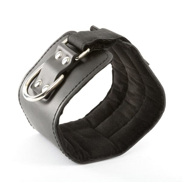 A black PU leather Cable Machine Ankle Cuff with a metal buckle and D-ring rests on a white background. It looks sturdy and adjustable, ideal for restraint or accessory purposes.