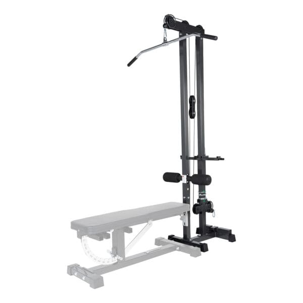 The Ironmaster Cable Tower Attachment V2, black and adjustable, is designed for home gyms. It features a padded seat, stabilizing bar, and a long lat pulldown bar. A weight bench is partially visible in the foreground.