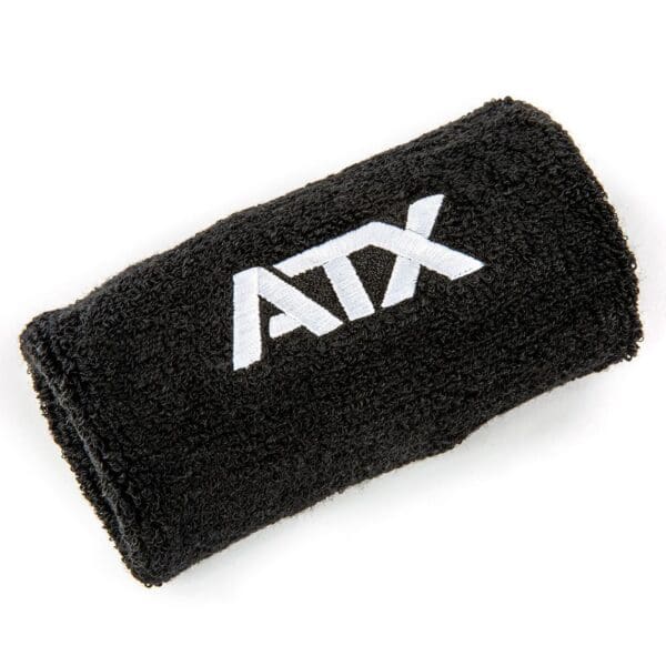 The Kettlebell Wrist Guard is a soft, absorbent black wristband with ATX embroidered in white, ideal for athletic use.