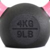 A black 4kg kettlebell with pink handles and 4KG and 9LB engraved on its surface.