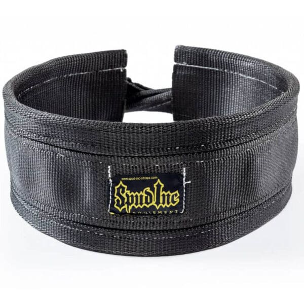 A black padded neck harness with reinforced stitching, an adjustable strap, and a label embroidered with Spud Inc in yellow and white.