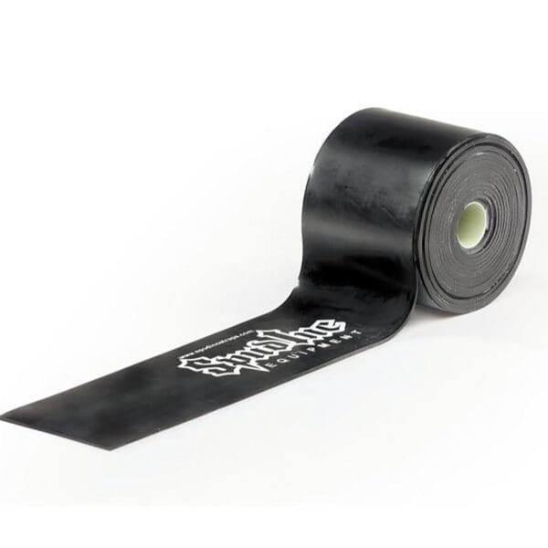 A black roll of Spud Inc Elephant Band with Stop A Flat in white is partially unrolled, showcasing a smooth texture and sturdy look, engineered to prevent punctures.