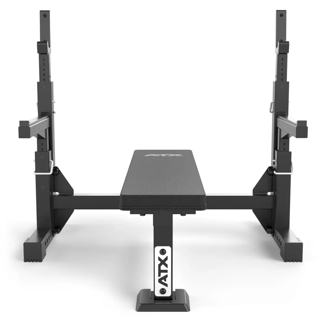 The ATX® Olympic Bench Press 700 features an adjustable bench with supports, ideal for bench pressing, equipped with a flat cushioned surface and a sturdy metal frame.