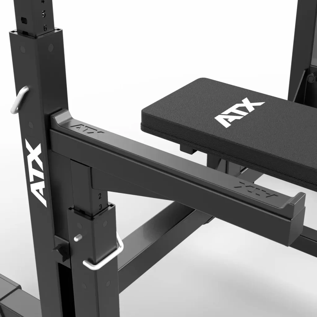 Close-up of the black ATX® Olympic Bench Press 700 with adjustable features. The brand logo and sturdy structure are highlighted, making it suitable for various exercises. The metal components show clearly visible adjustment mechanisms.