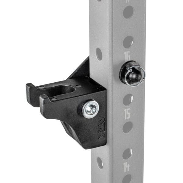 Close-up of the ATX® Bar Holder, a black metal bracket attached to a gray vertical pole with numbered holes, used in exercise equipment. It is secured with bolts and has a hook-like design for holding weights or accessories.