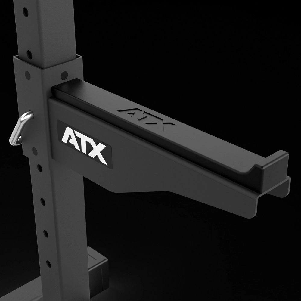 Close-up of a black ATX® Squat Stands 510 safety spotter arm attached to a power rack, with an adjustment pin visible on the left side, set against a black background—ideal for home gym setups.