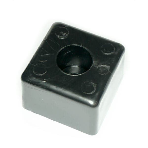A Bump Stop 50mm x 50mm, black with a textured surface, features a central hole, rounded edges, and four raised circles at each corner.