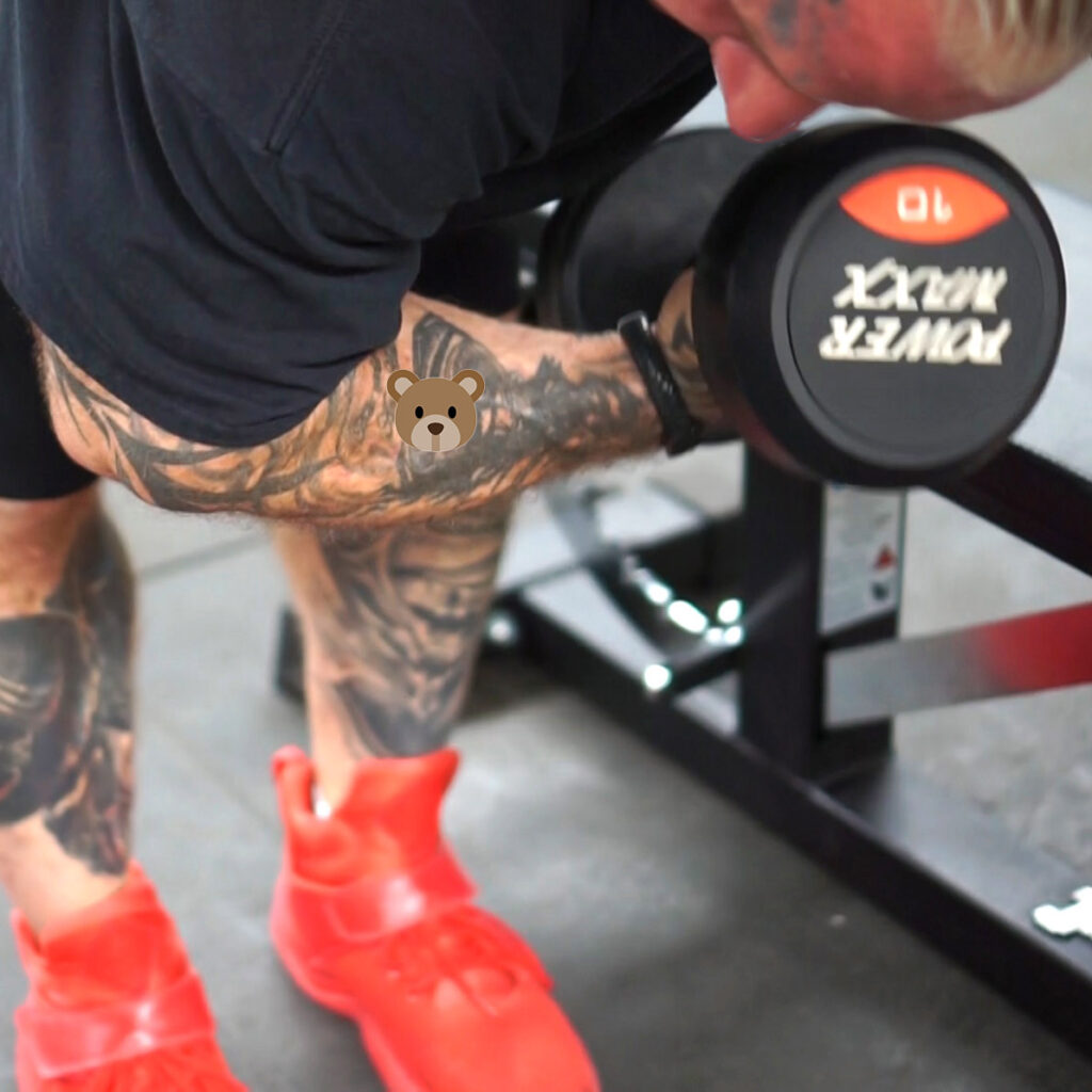 Lee Priest doing a concentration curl.