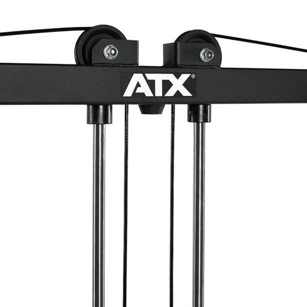 Close-up of a black ATX® Cable Crossover Weight Stack 90 kg gym machine with two pulleys and cables, displaying the ATX brand name in white. The image highlights the upper section where the cables run through the pulleys.
