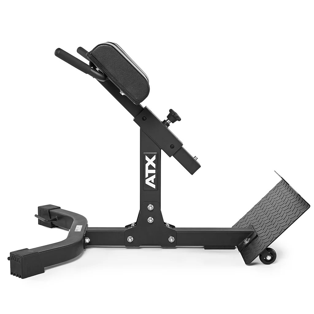 The image shows the ATX® Hyperextension Machine 650, commonly referred to as a roman chair. It is a sleek black exercise bench that includes padded support and adjustable angle settings. Designed for fitness workouts, it features stabilizing feet and a textured foot platform to facilitate effective back extensions.