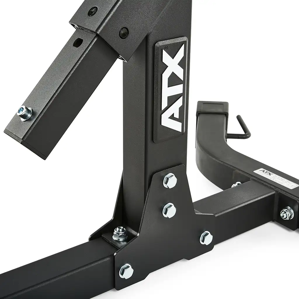 Close-up of the ATX® Hyperextension Machine 650 gym equipment frame in black, highlighting its robust metal construction with bolts and a hook attachment, similar to part of a hyperextension bench. The image emphasizes the junction where the vertical and horizontal beams meet.