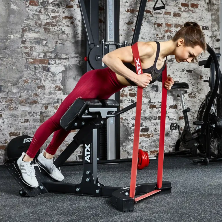 woman training on the ATX Hyper Extension machine with resistance bands